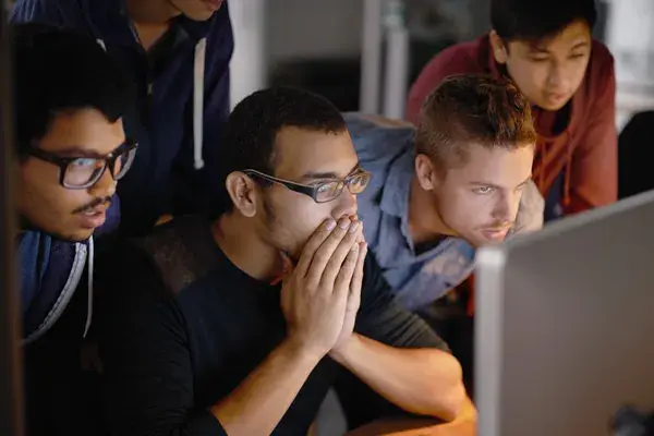Software developers viewing a desktop computer