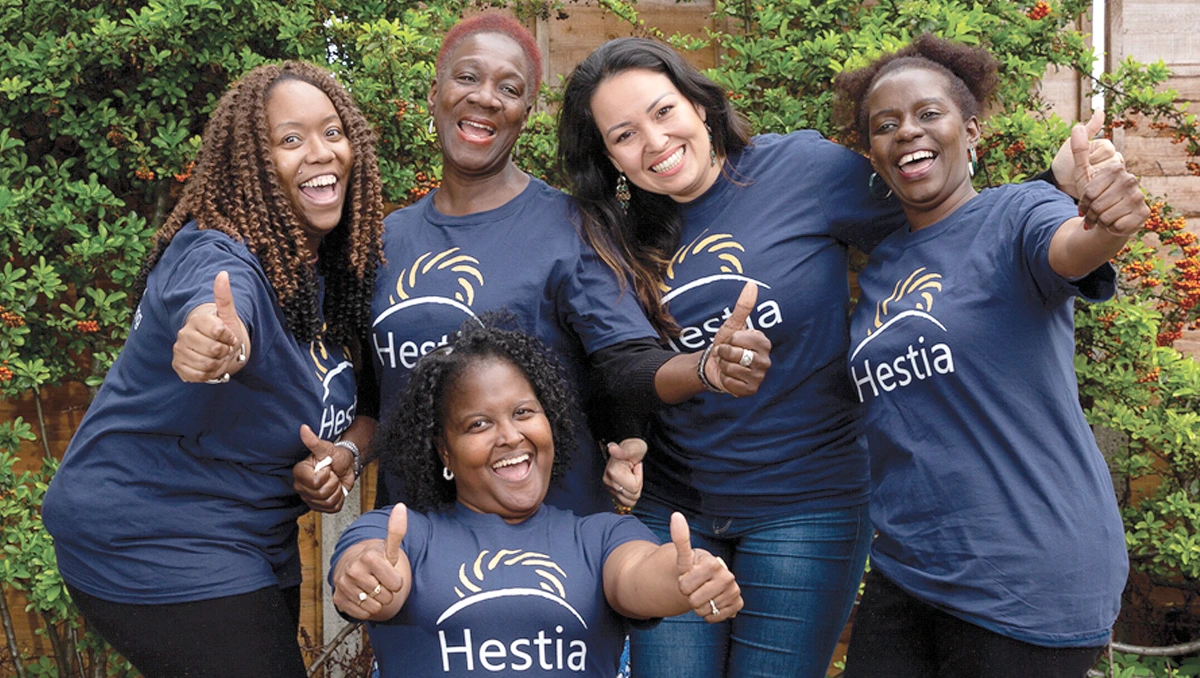 Group of women wearing Hestia t-shirts smiling at the camera