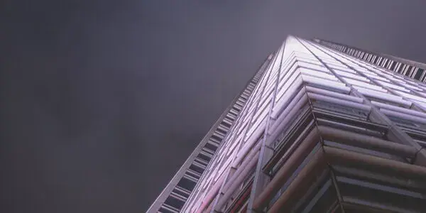 Sinister image of modern architectural structure illuminated against a dark sky